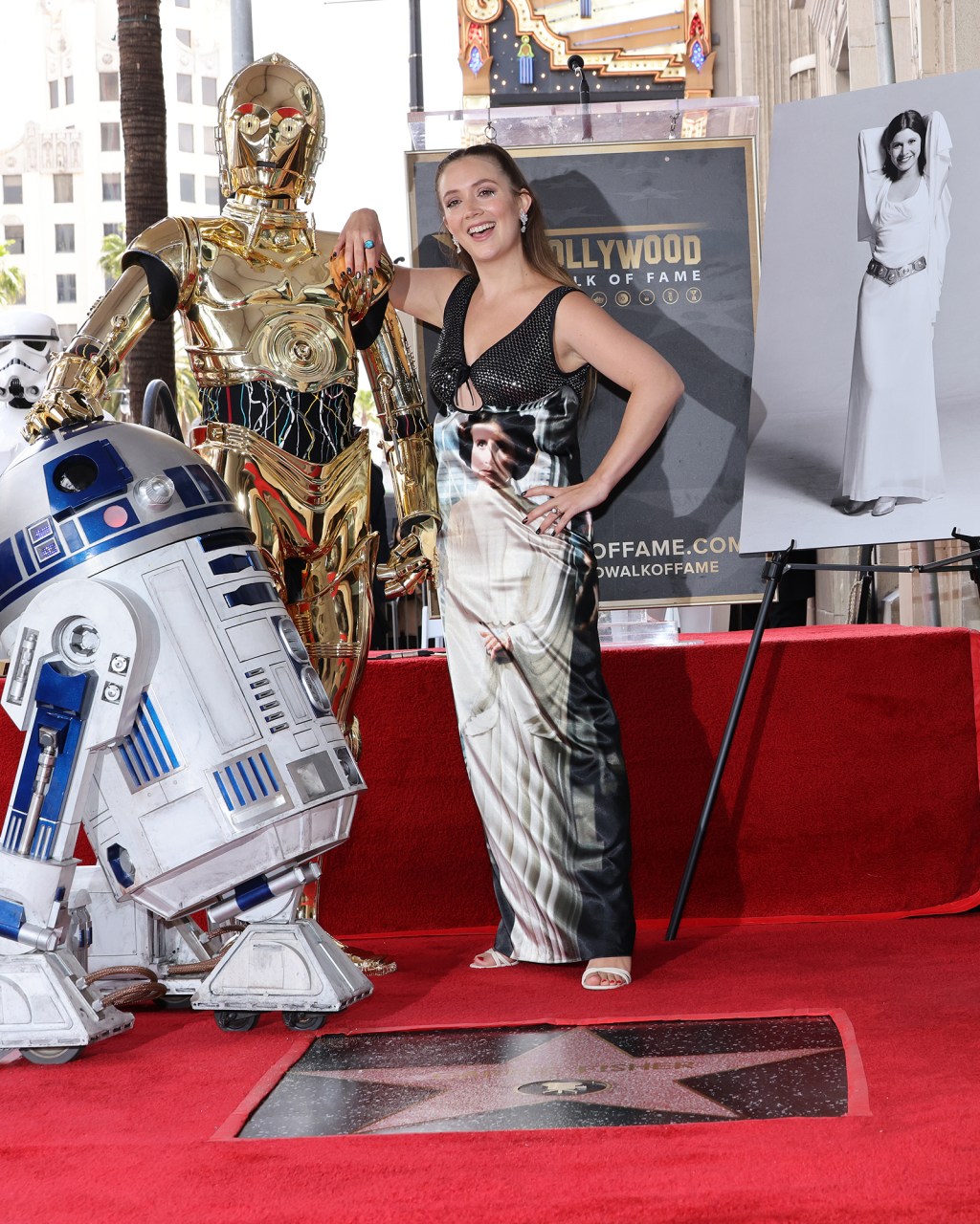 Billie Lourd poses alongside C-3PO and R2-D2 at Carrie Fisher's Hollywood Walk of Fame ceremony.