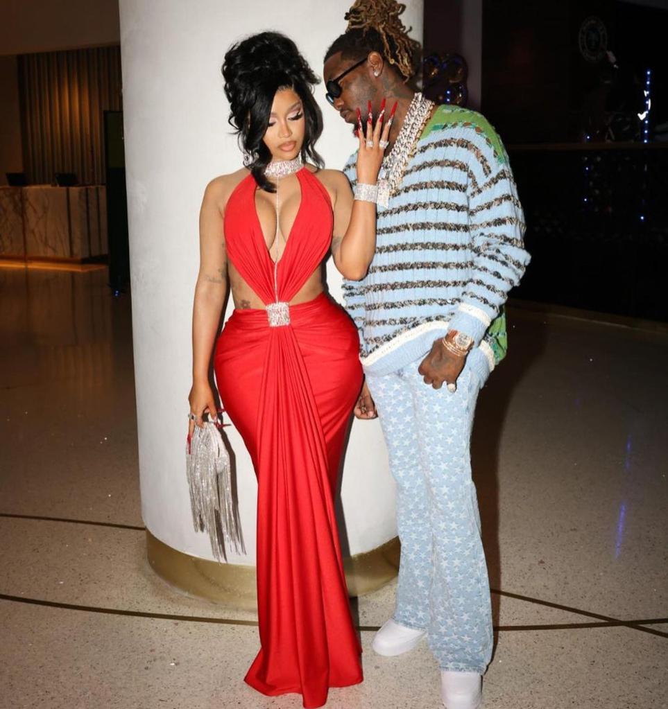 Cardi B, Offset standing together as Cardi B wears red dress