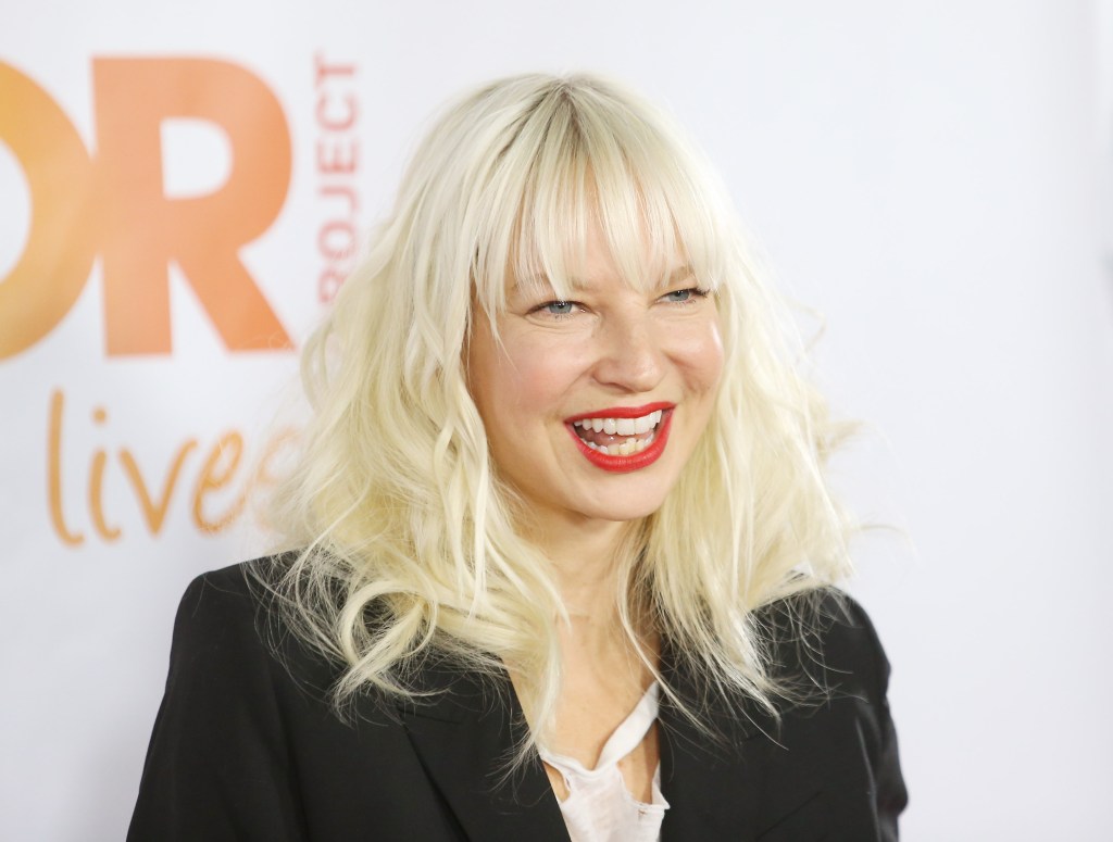 Sia smiling on a red carpet.