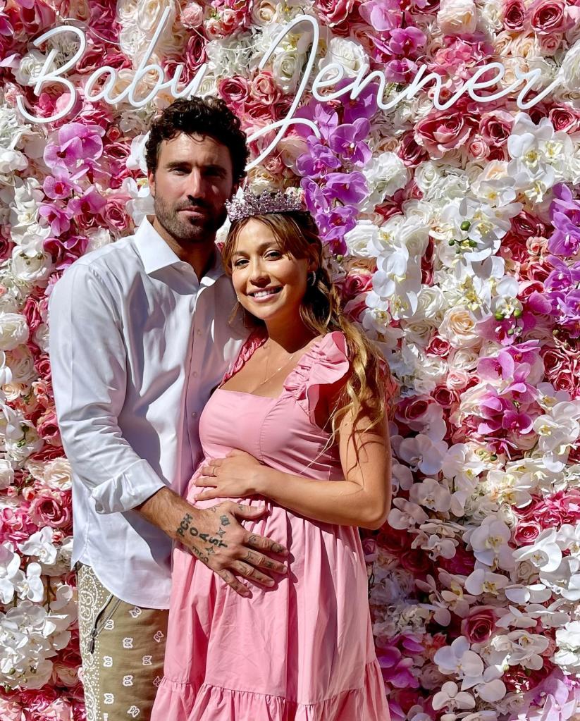 brody and Tia smiling in front of flower wall