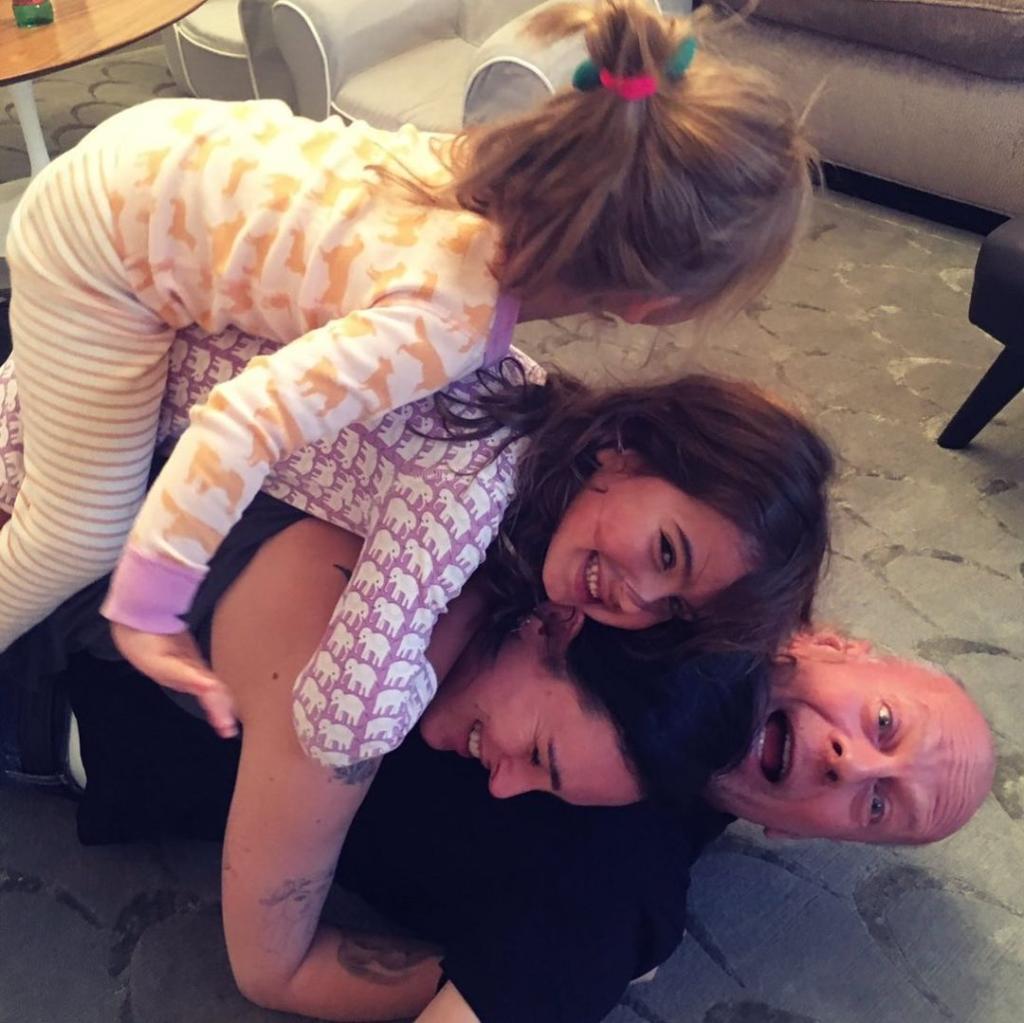 Bruce Willis is tackled by Emma Heming and daughters Mabel and Evelyn