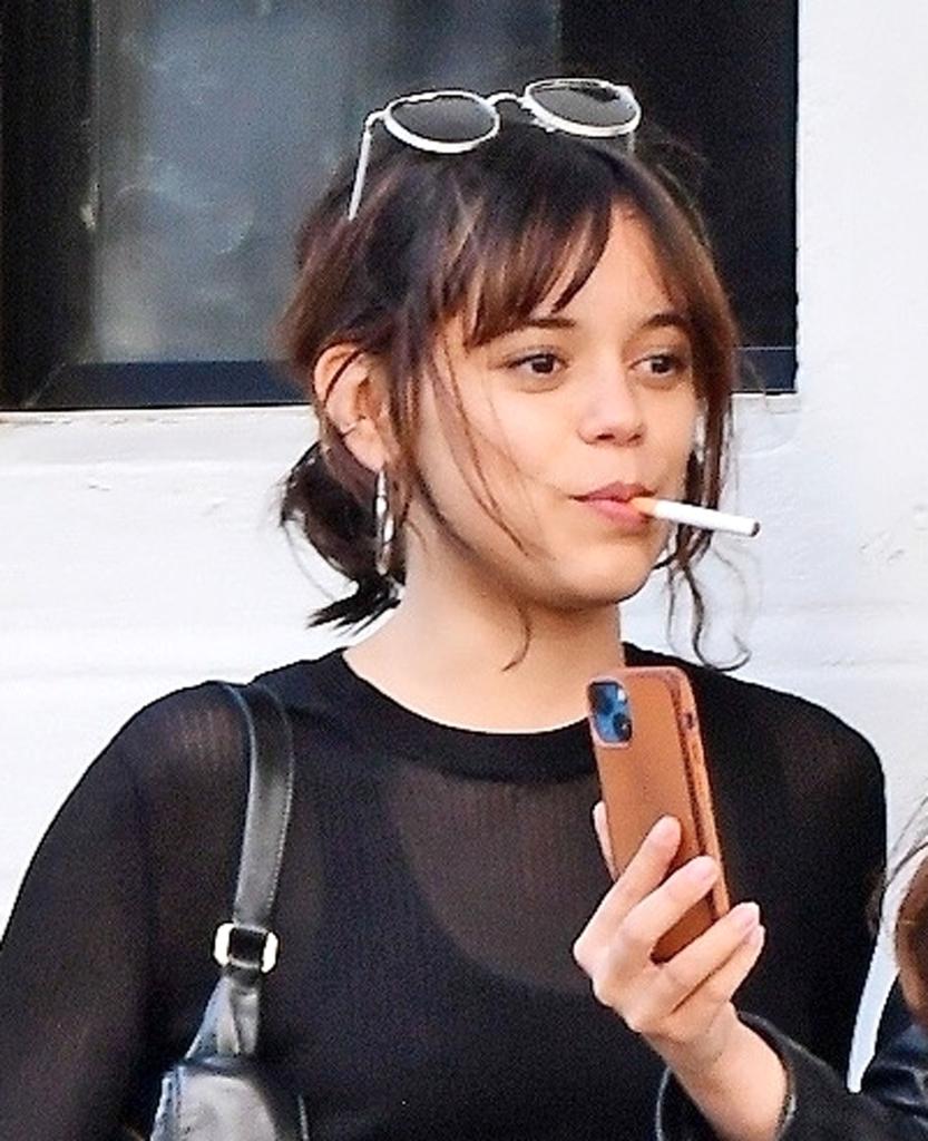 Jenna Ortega smoking in London.