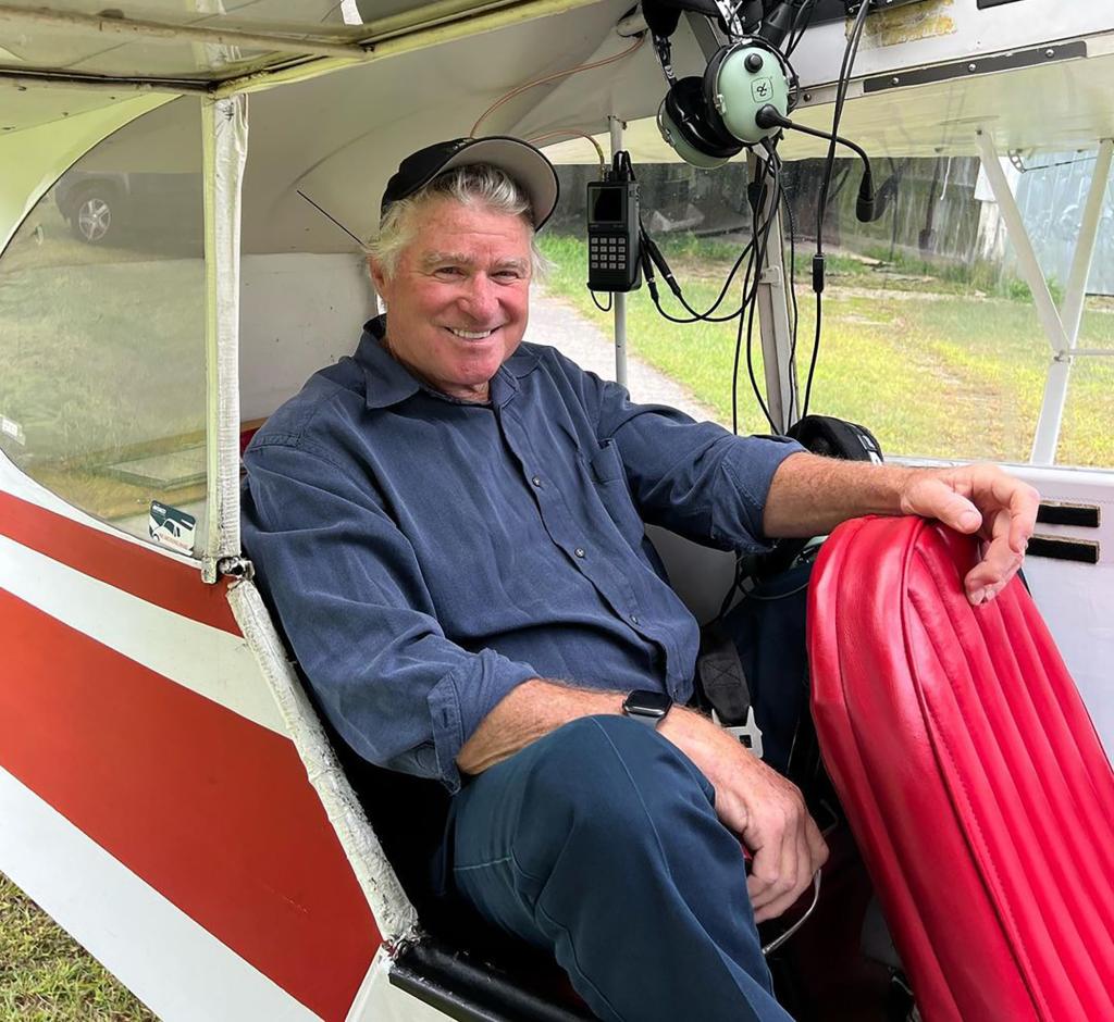 Treat Williams sitting in a helicopter.
