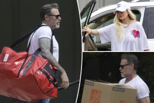 Dean McDermott with moving Boxes and Tori Spelling in "Boys Lie" shirt.