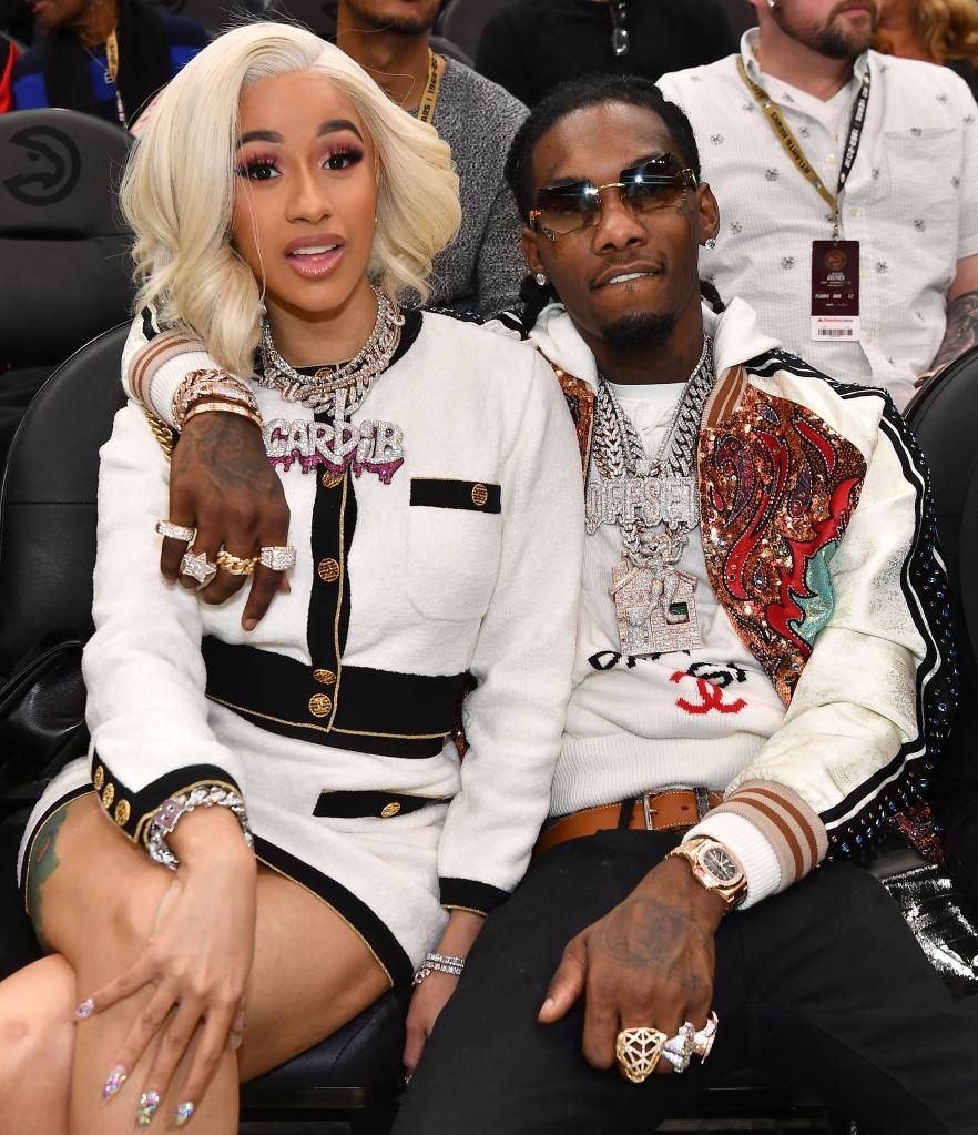 Cardi B and Offset seated front row at NBA game.