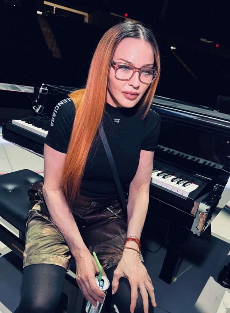 madonna sitting at a piano