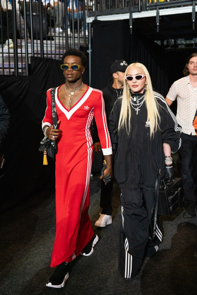 Madonna and David Banga walking outside.