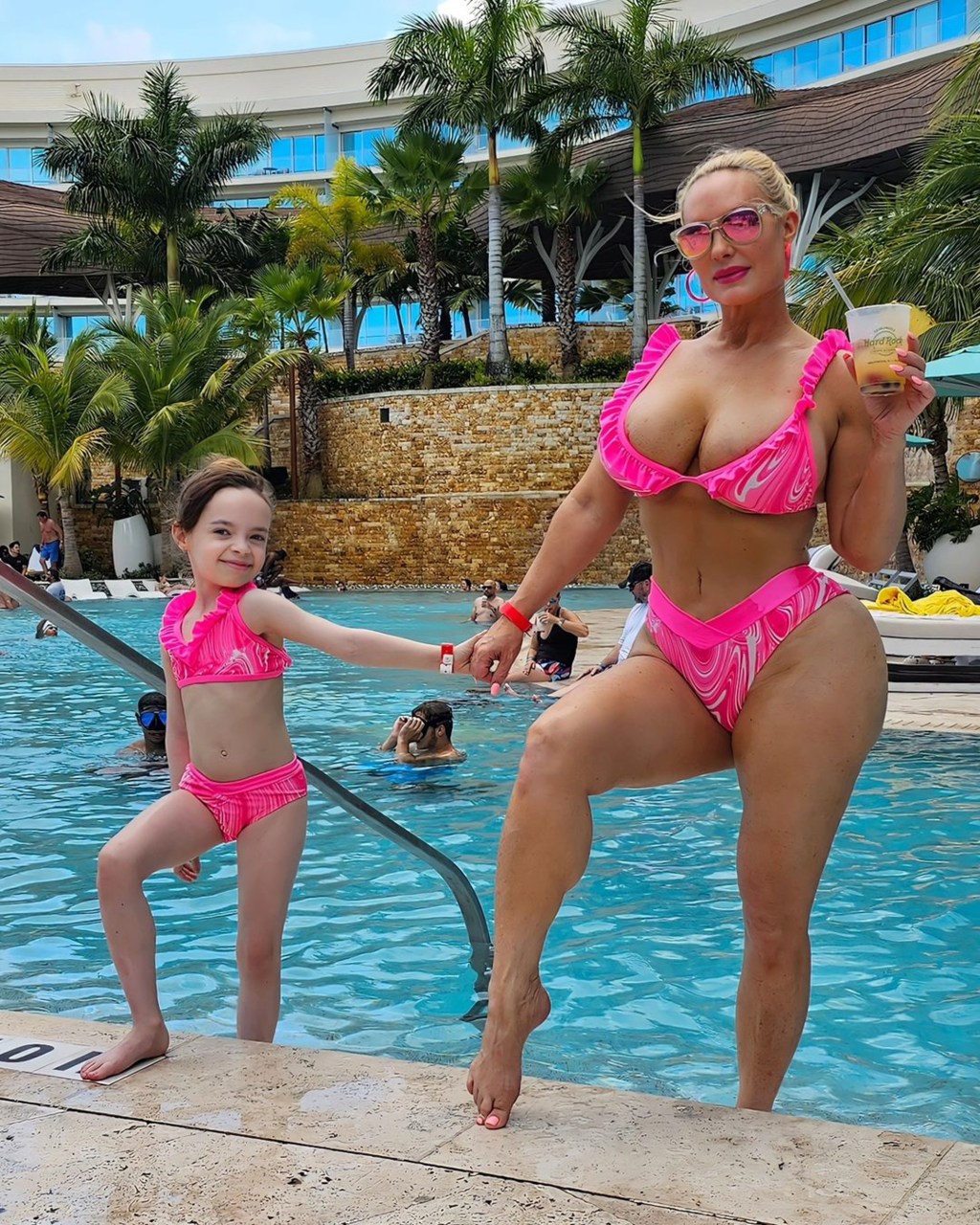 Coco Austin and Chanel Austin posing, smiling poolside.