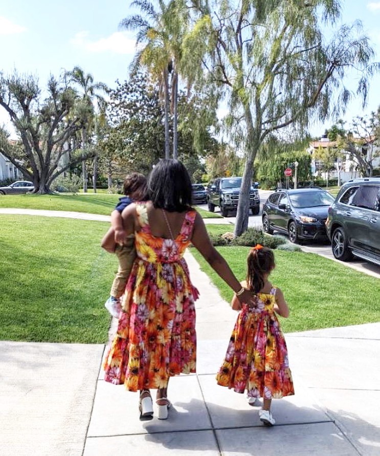 Mindy Kaling walking with two children 