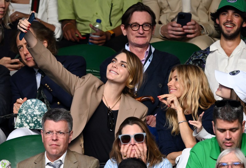 Cara Delevingne and Sienna Miller take a selfie at Wimbledon on July 10, 2023. 