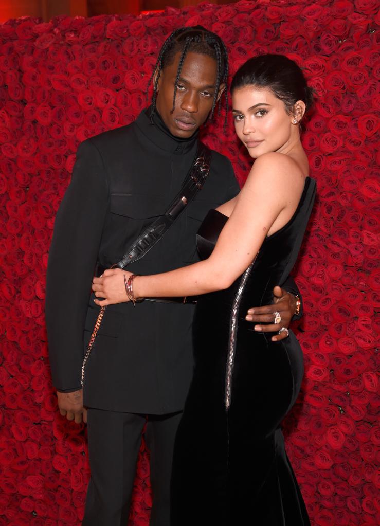 Travis Scott and Kylie Jenner posing together at an event.