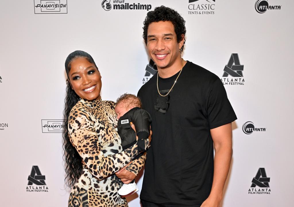 Keke Palmer and Darius Jackson with their son on a red carpet. 