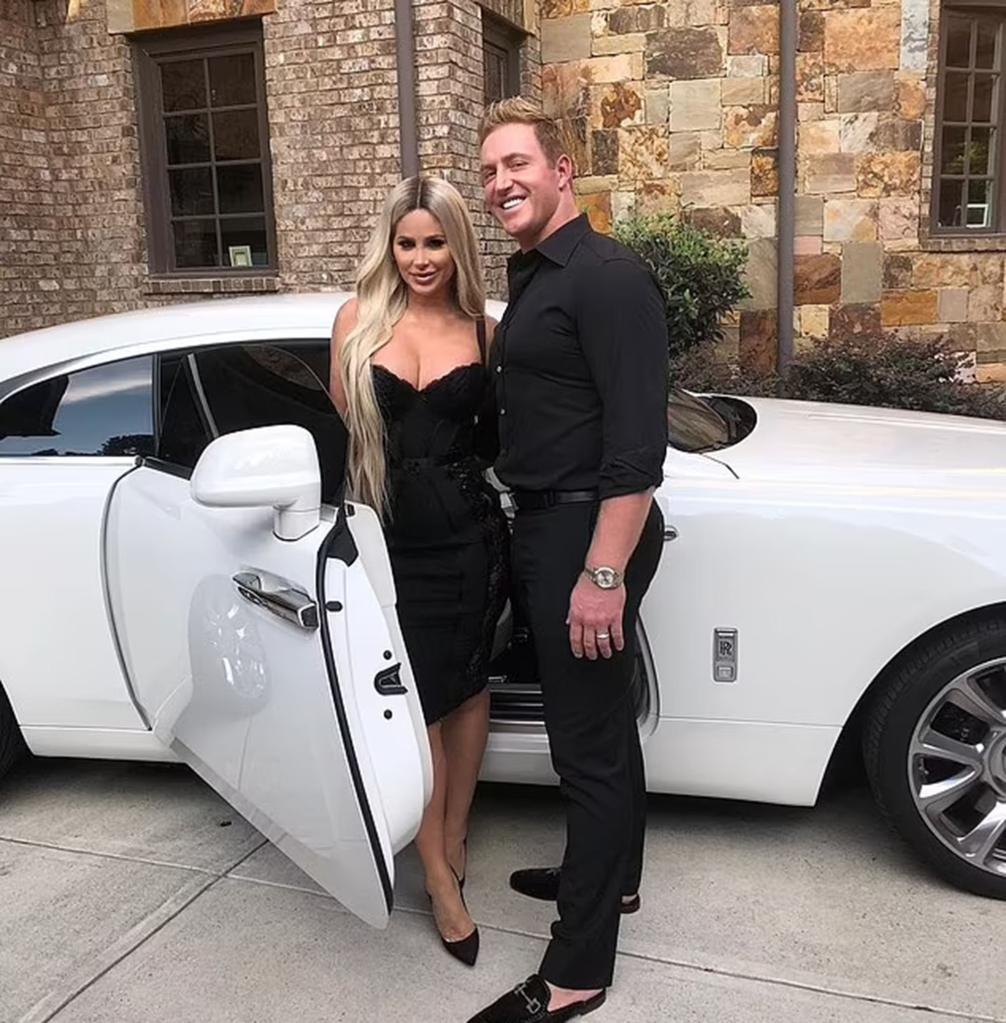 Kim Zolciak and Kroy Biermann posing outside a car