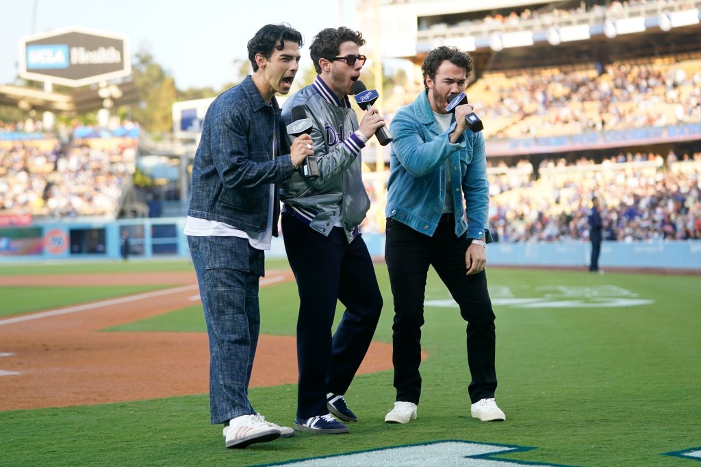 Nick Jonas, Joe Jonas and Kevin Jonas performing at a Dodger's gam e in Los Angeles. 