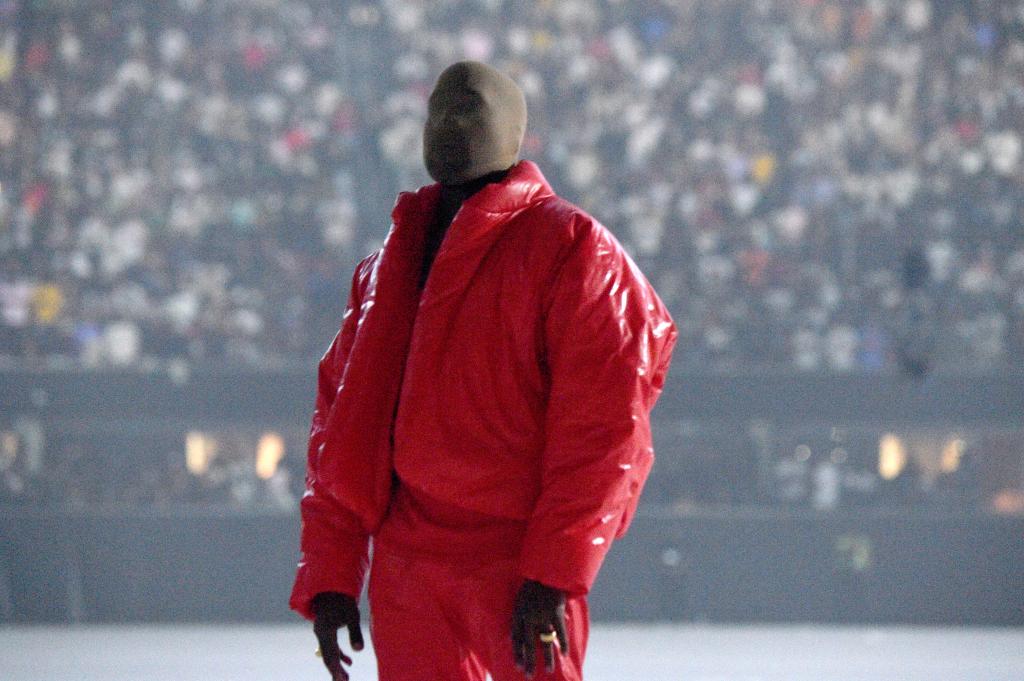Kanye West wearing a red mask.