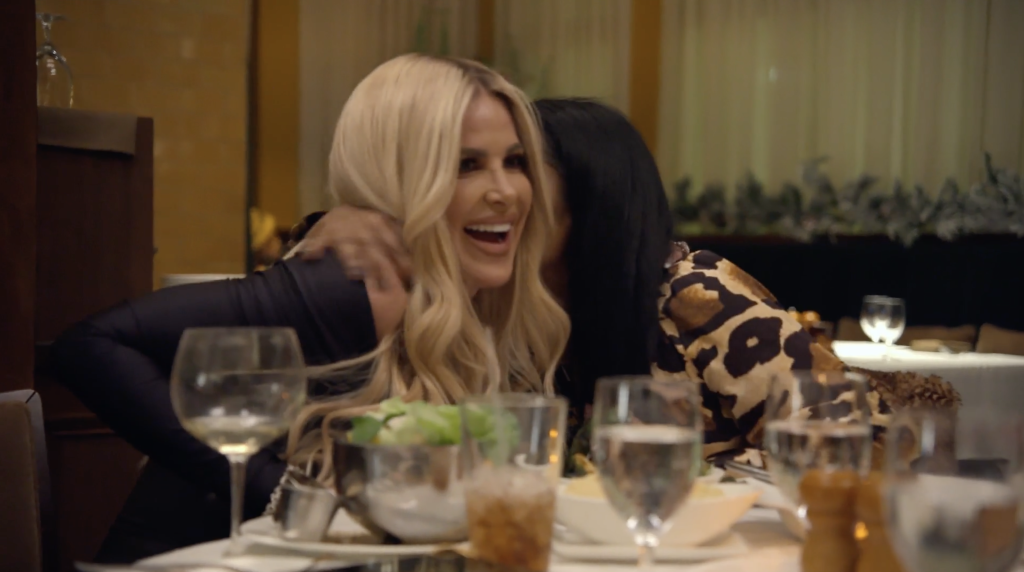 kim zolciak smiling at a restaurant table