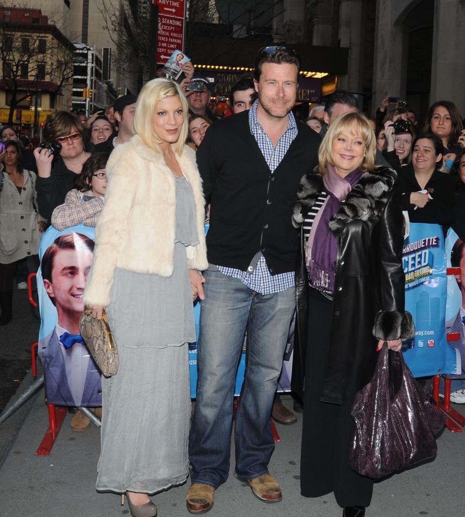 Tori Spelling, Dean McDermott and Candy Spelling posing at an event together.