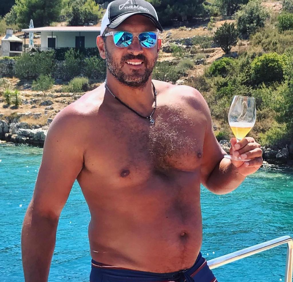 Mauricio Umansky on a boat with wine.