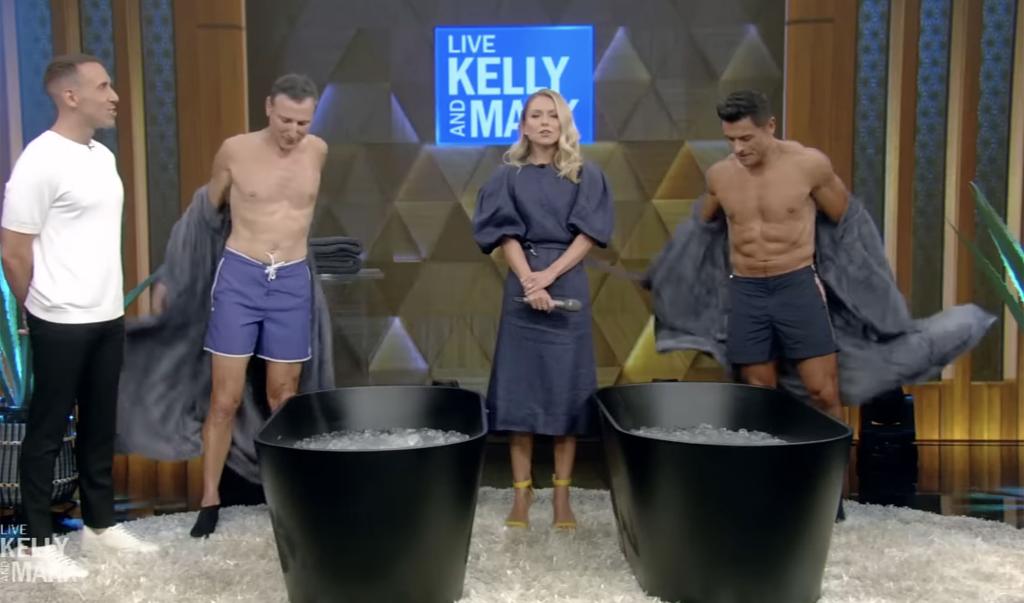 Shirtless Mark Consuelos getting into an ice tub