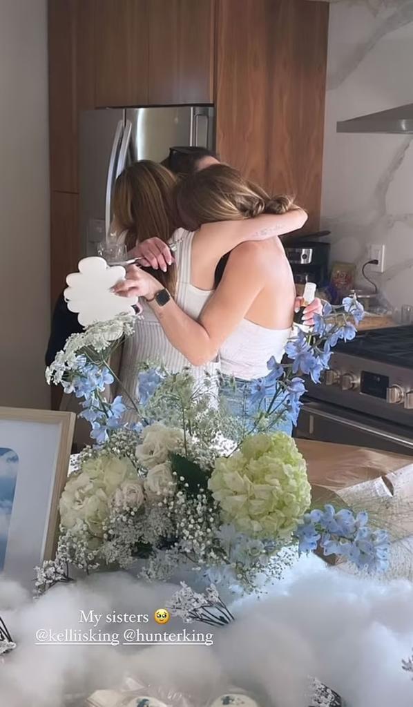 Joey King and her two sisters hugging