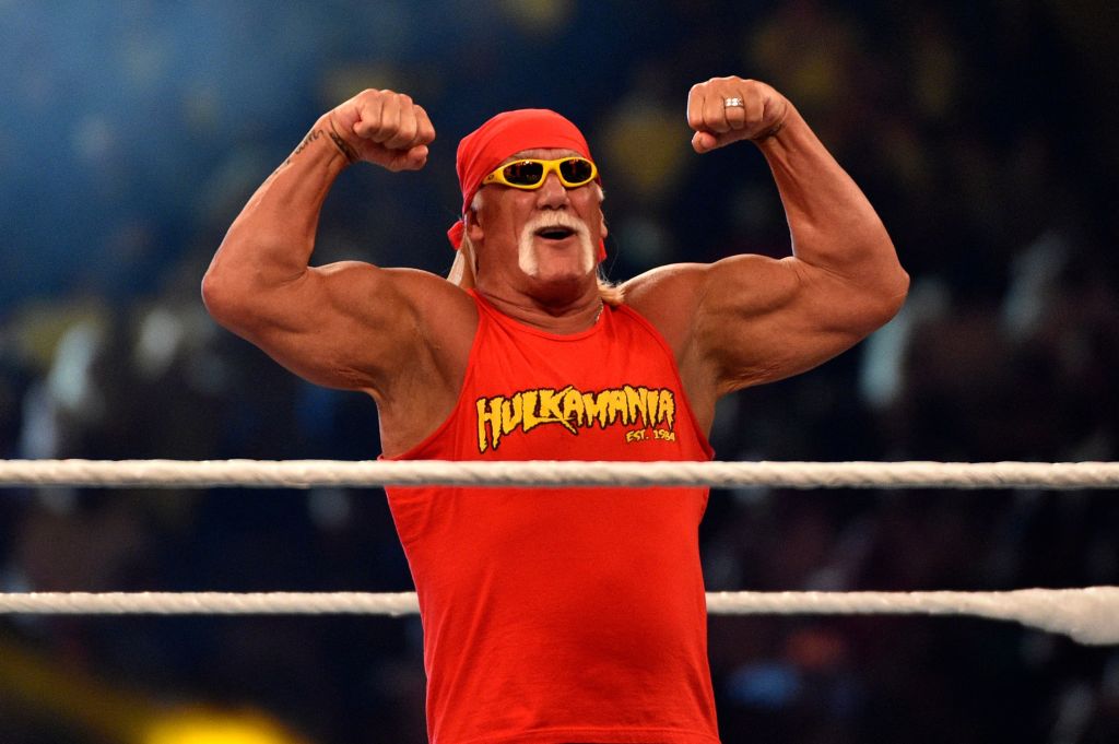 hulk hogan flexing his arms in a wrestling ring