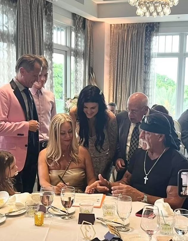 hulk hogan, sky daily and friends standing at a restaurant table