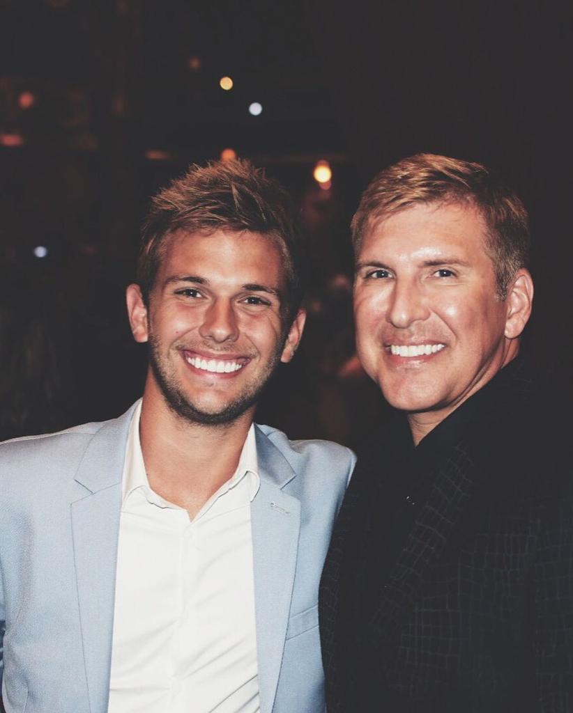 Chase and Todd Chrisley smiling for a photo together 