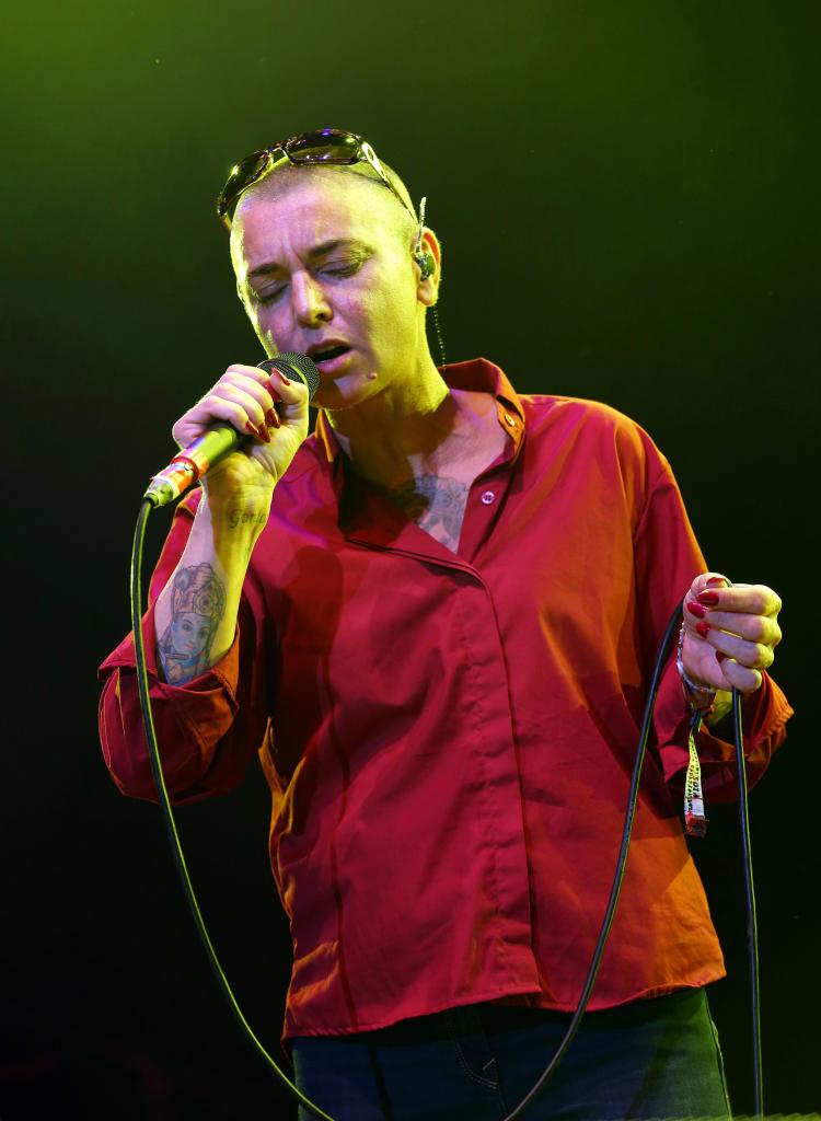 Sinéad O'Connor on stage. 