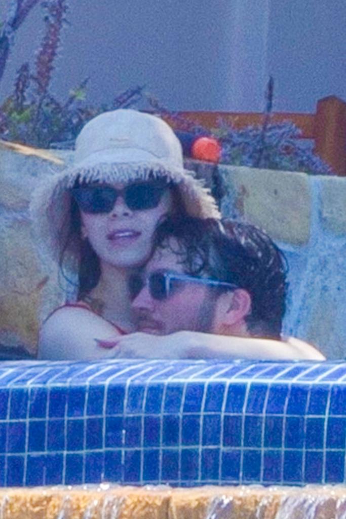 josh allen and hailee steinfeld in a pool cuddling