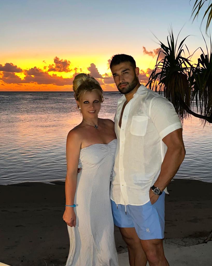 Britney Spears and Sam Asghari in front of a sunset