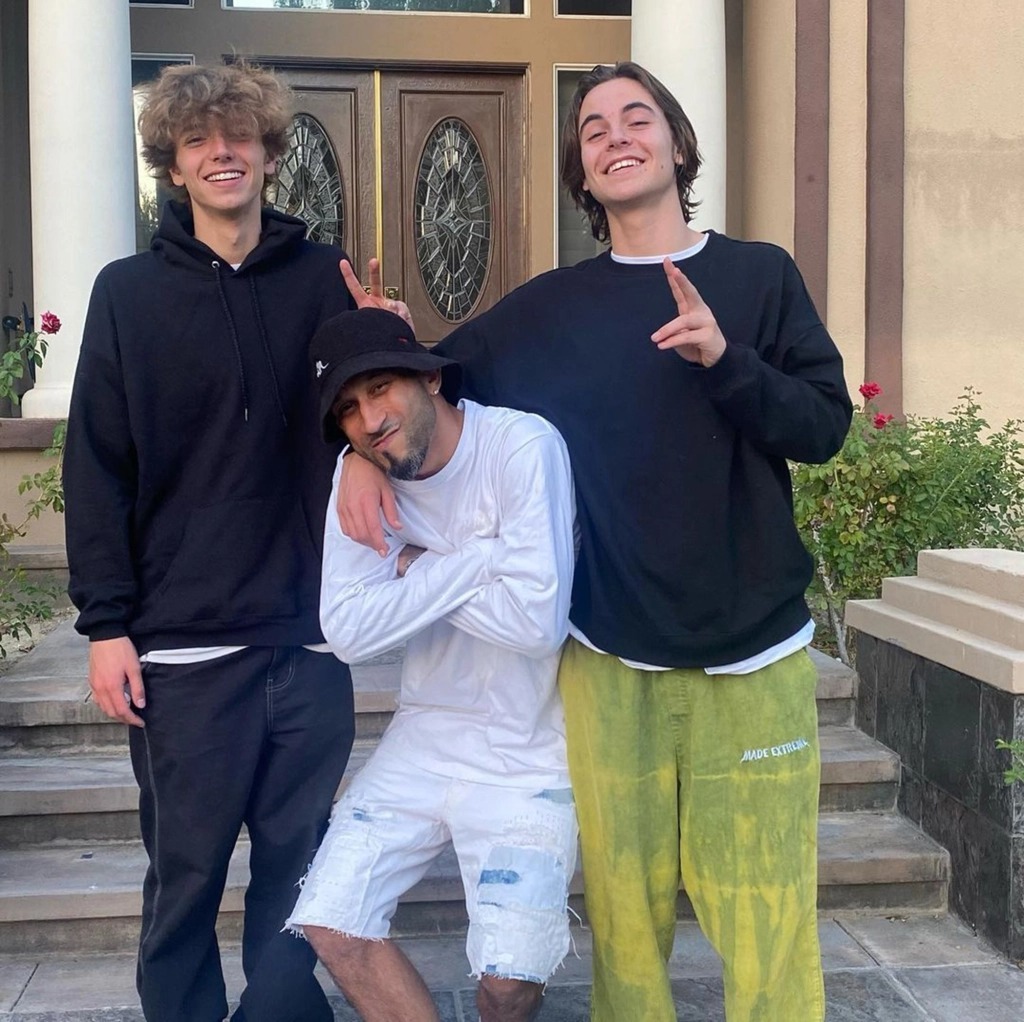 Sean Preston Federline and Jayden Federline posing with a friend in front of a house.