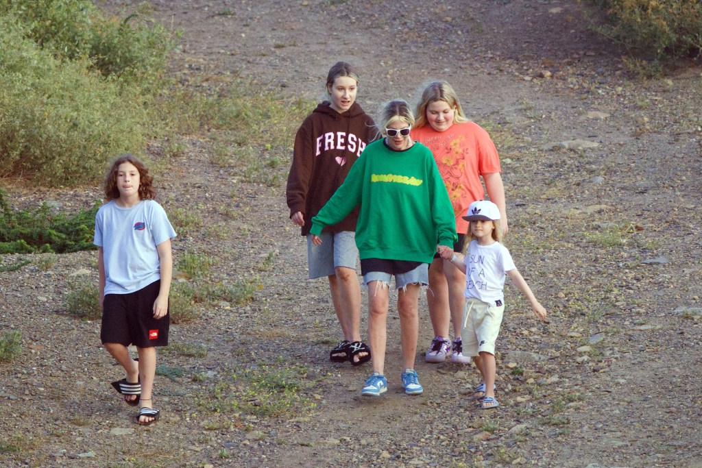 tori spelling and kids walking through woods