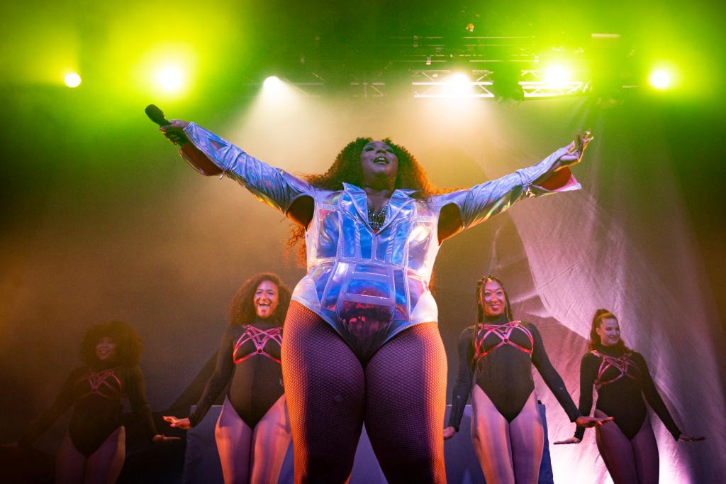 Lizzo performing on stage. 