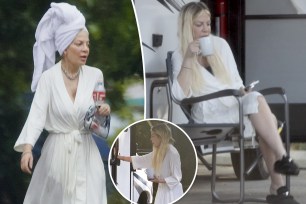 Tori Spelling in a robe outside of her RV.