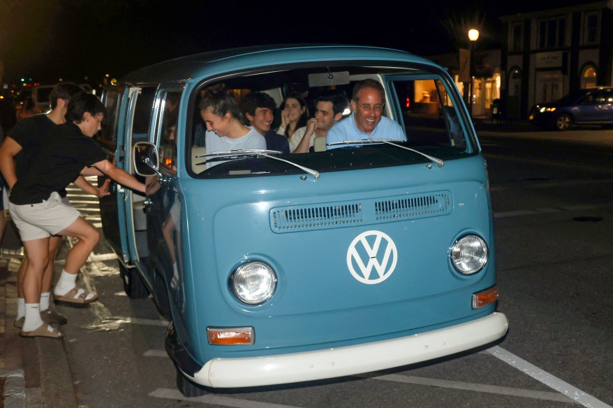 jerry seinfeld driving a vintage VW bus with his family inside