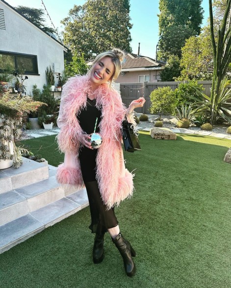 emma roberts posing in a backyard