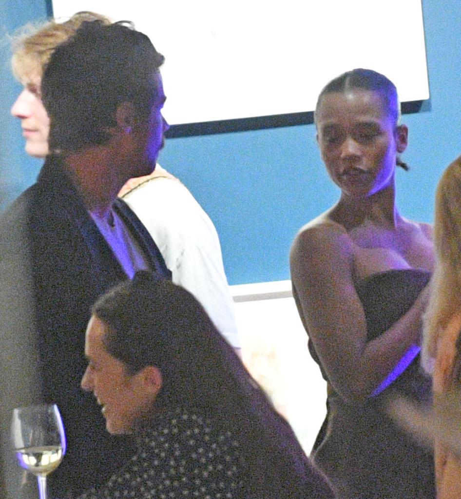 harry styles looking at taylor russell at a party
