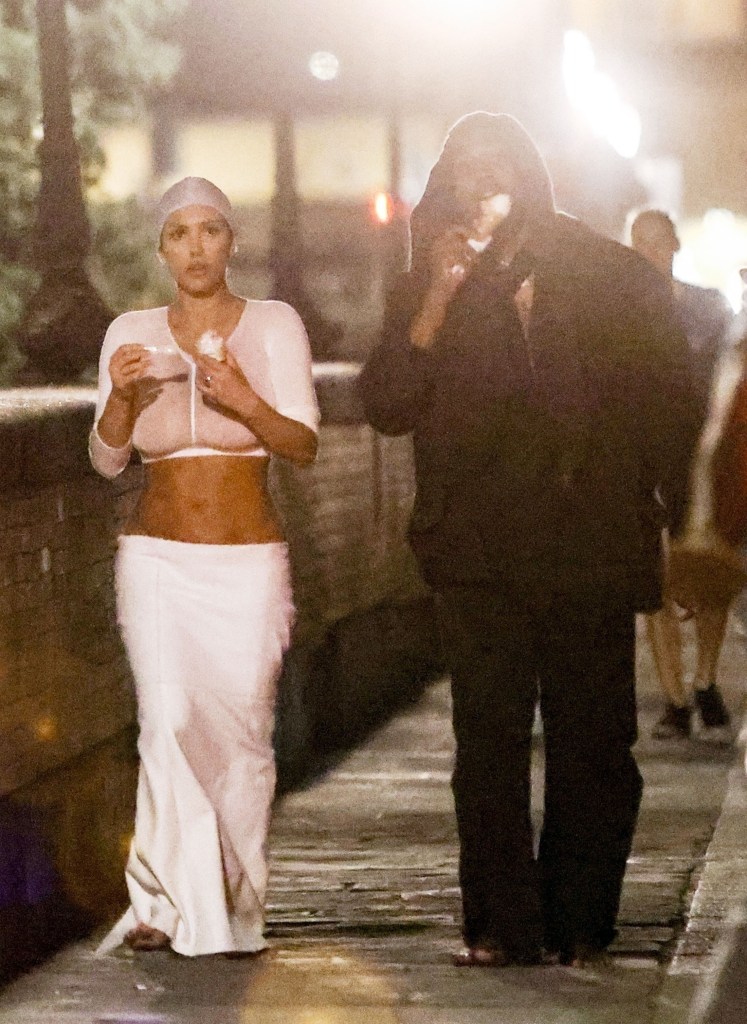 Kanye West, Bianca Censori walking and eating gelato
