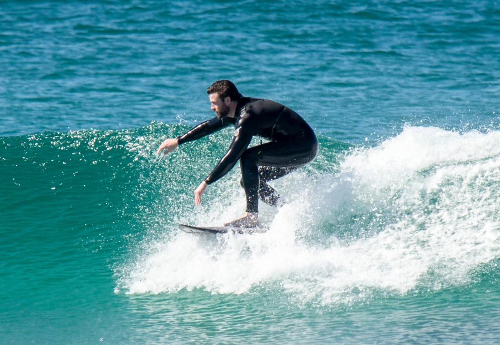 Liam Hemsworth surfing.