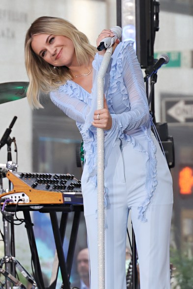 Kelsea Ballerini leaning away from a mic