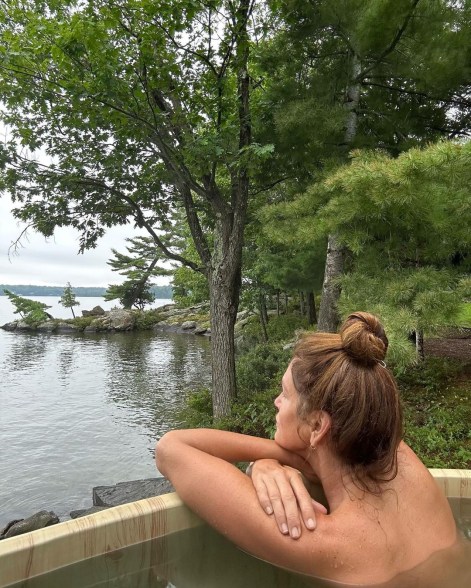 topless cindy crawford in a hot tub looking at a lake