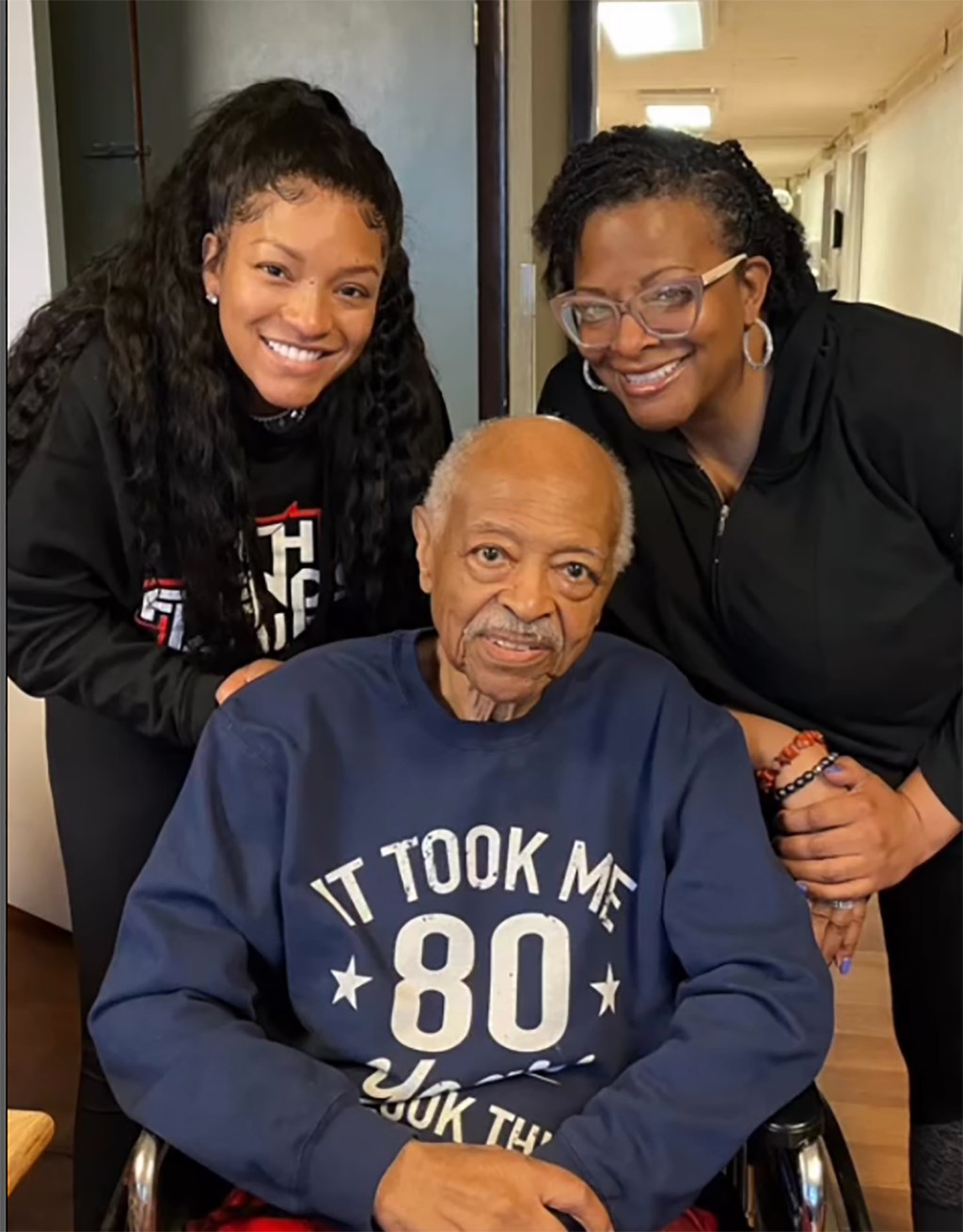 Drew Sidora posing with her dad and someone else.