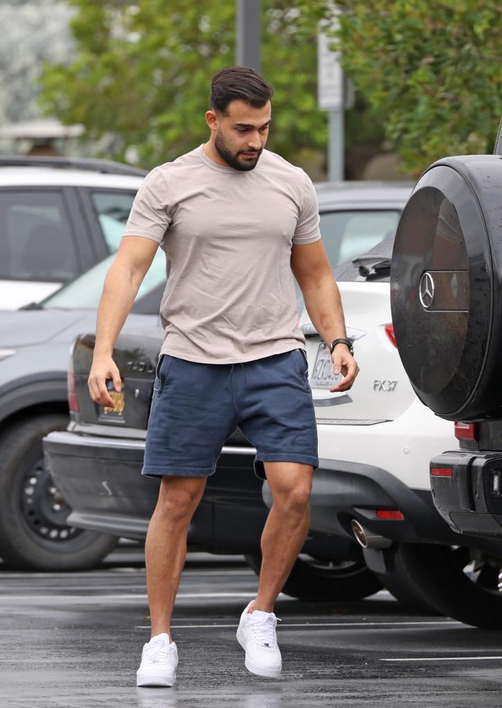 Sam Asghari going into a sports complex.