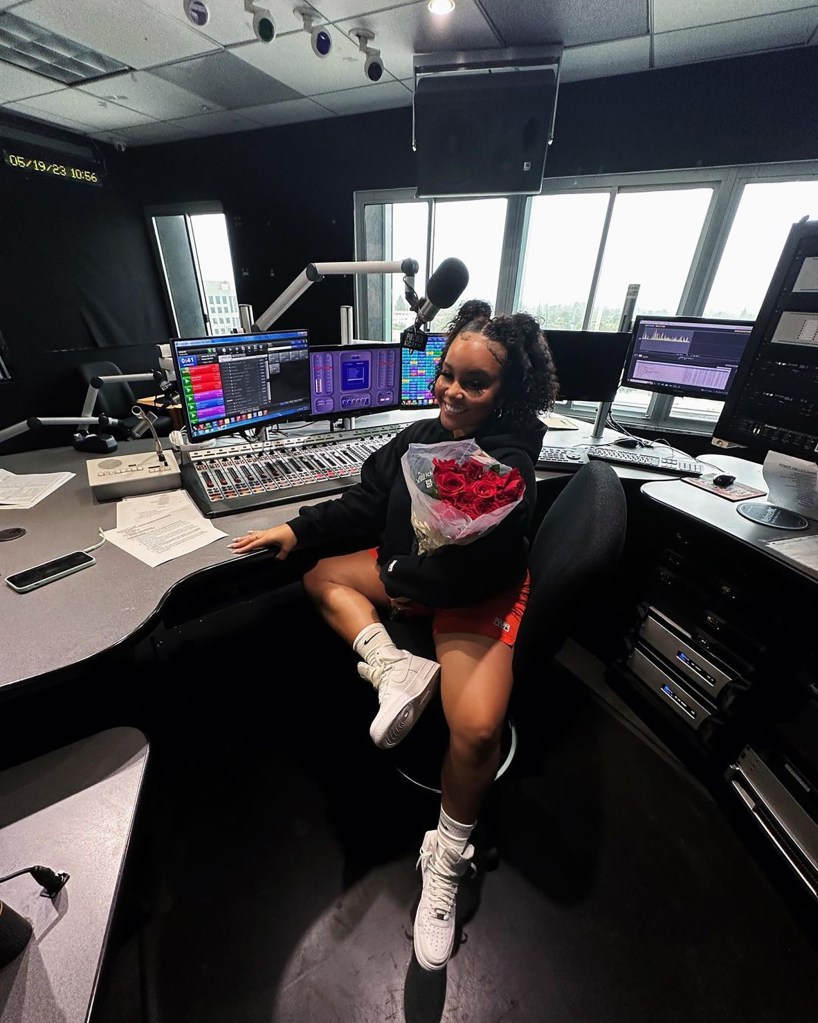 radio host Bryhana Monegain sitting at her desk