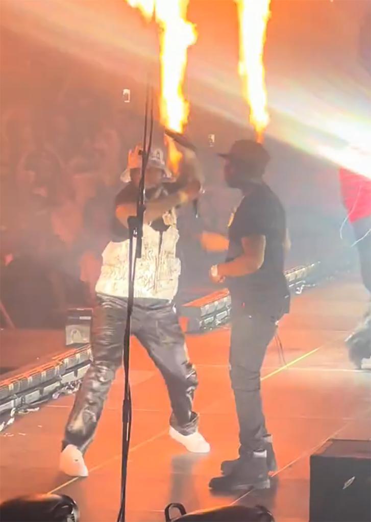 50 cent hurling a mic into the crowd next to rapper YG