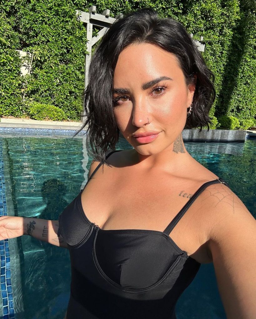 A selfie of Demi Lovato by a pool.