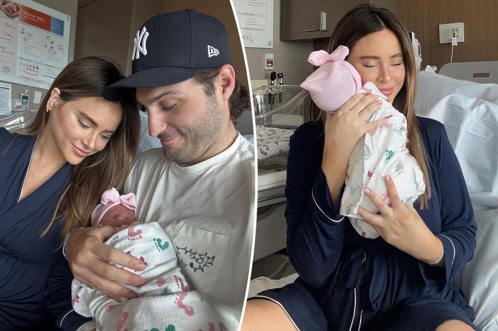 Amanda Stanton and Michael Fogler holding baby