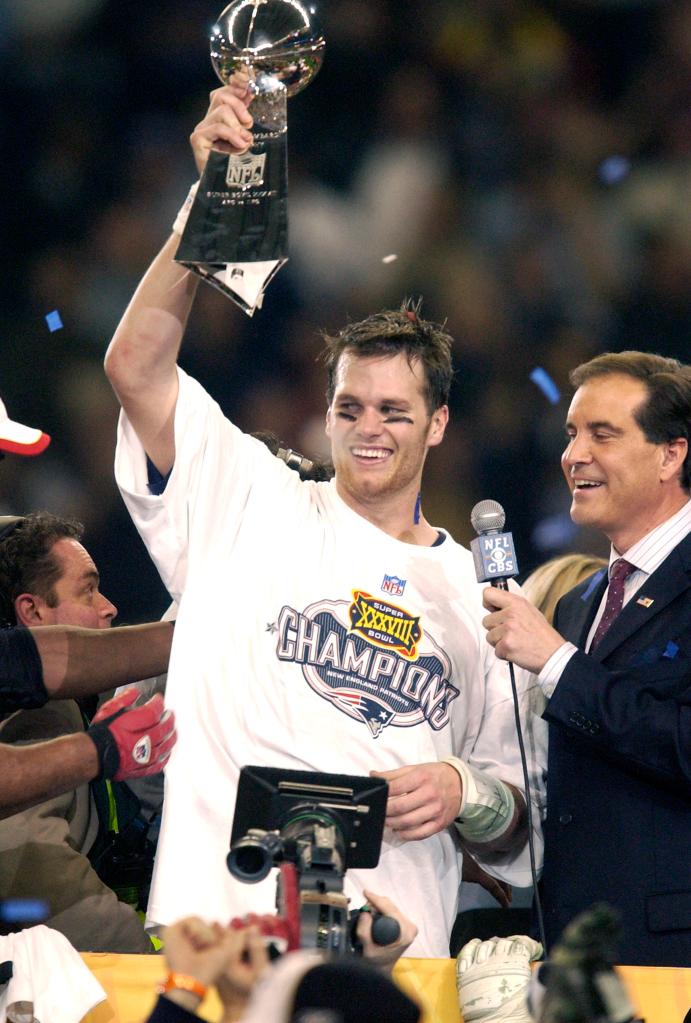 Tom Brady holding up the Lombardi Trophy.