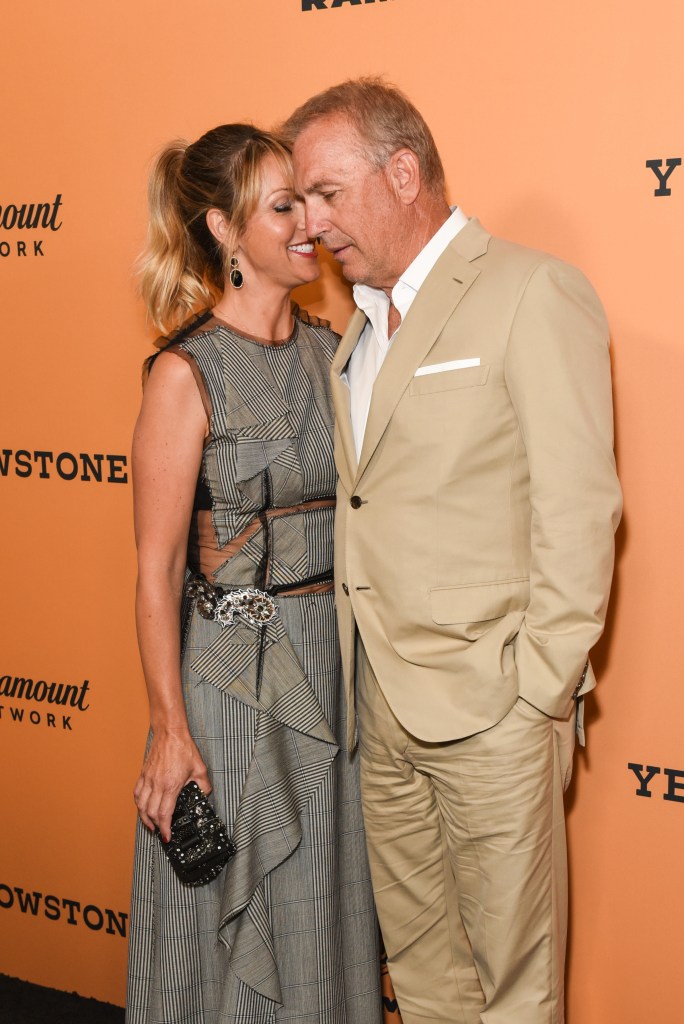 christine baumgartner and kevin costner canoodling on the red carpet