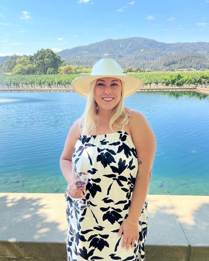 Alaina Scott posing in front of a lake.